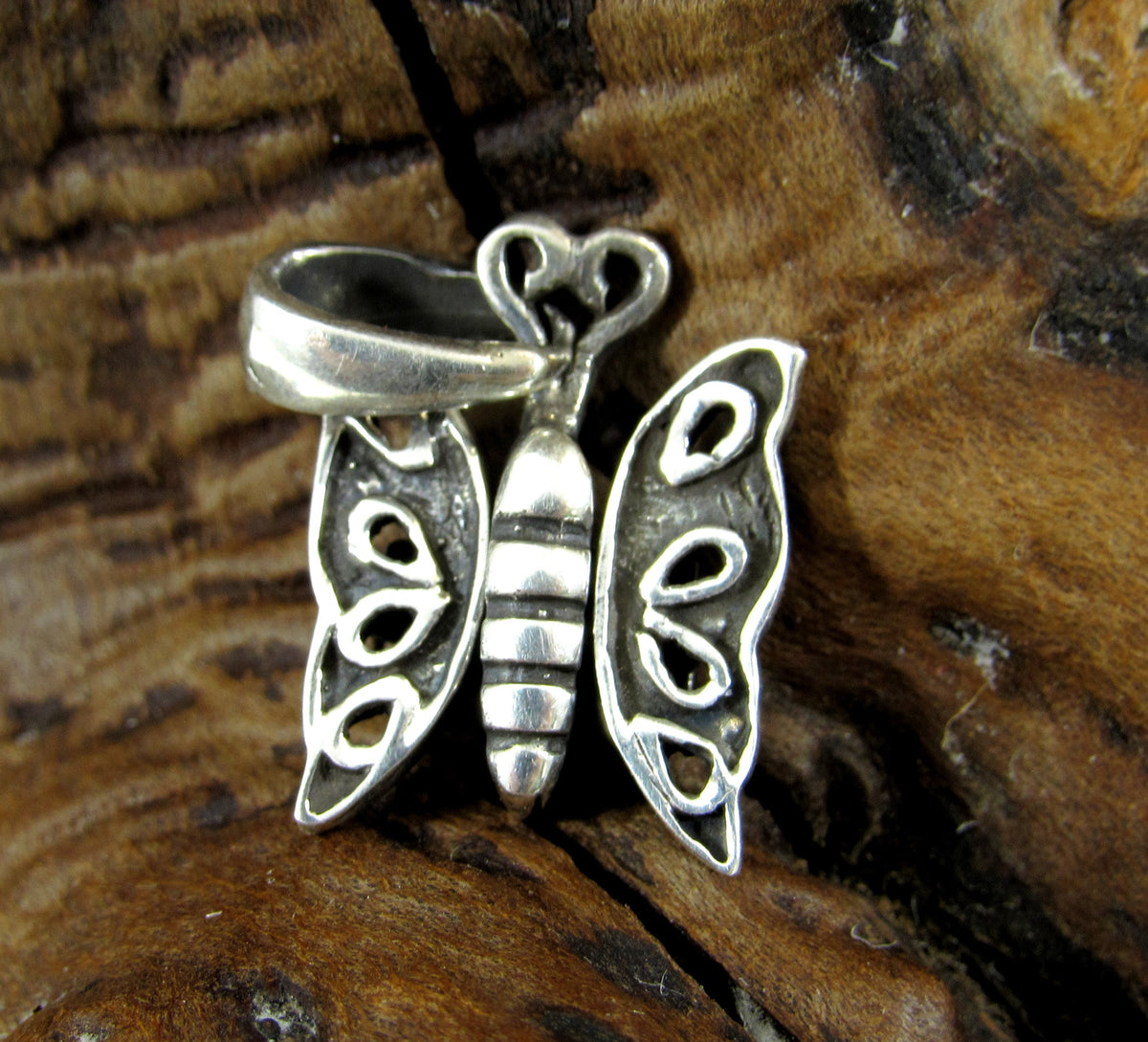 The handcrafted sterling silver butterfly charm has wings that move on hinges